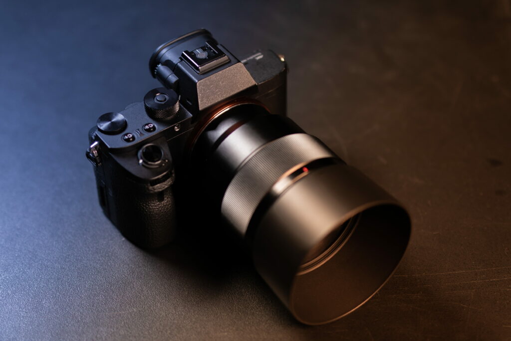 Sony mirrorless camera in dual-tone blue and amber lighting studio shot for photography fans Wallpaper