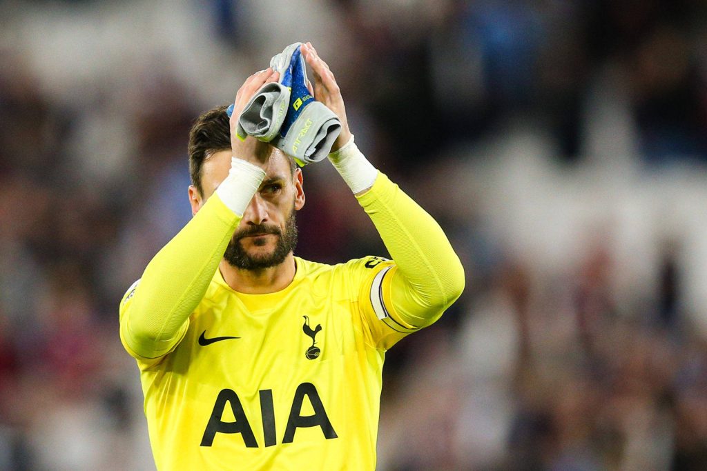 Hugo Lloris clapping in bright yellow Tottenham Hotspur kit and Reusch gloves stadium wallpaper