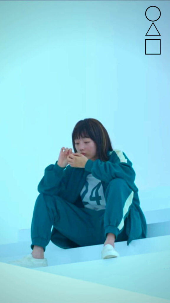 Ji-Yeong's Delicate Reflection: A Caring Soul amidst the Squid Game Wallpaper