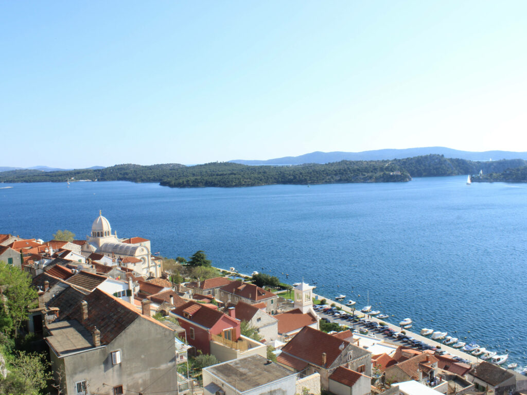 St James Cathedral Croatia dome charming old town rooftops blue waters green hills background Wallpaper
