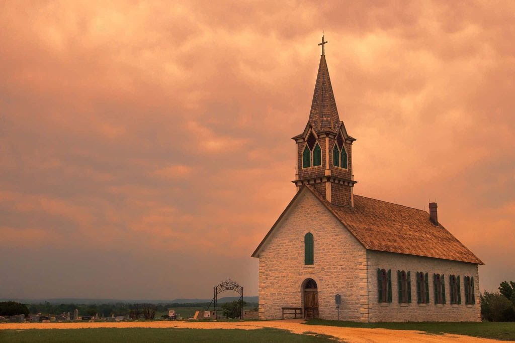 Historic St Johns Lutheran Church Priddy Texas stone church steeple sunset serene sky Wallpaper