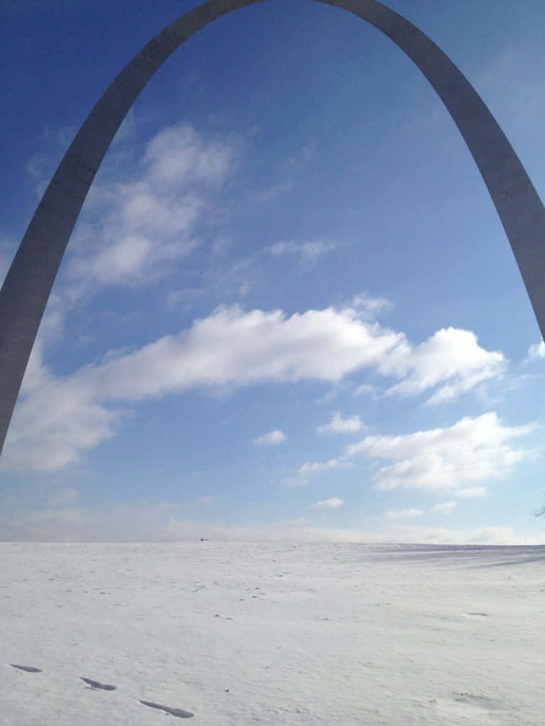 St Louis Gateway Arch in winter snow with blue sky clouds serene iconic landmark wallpaper