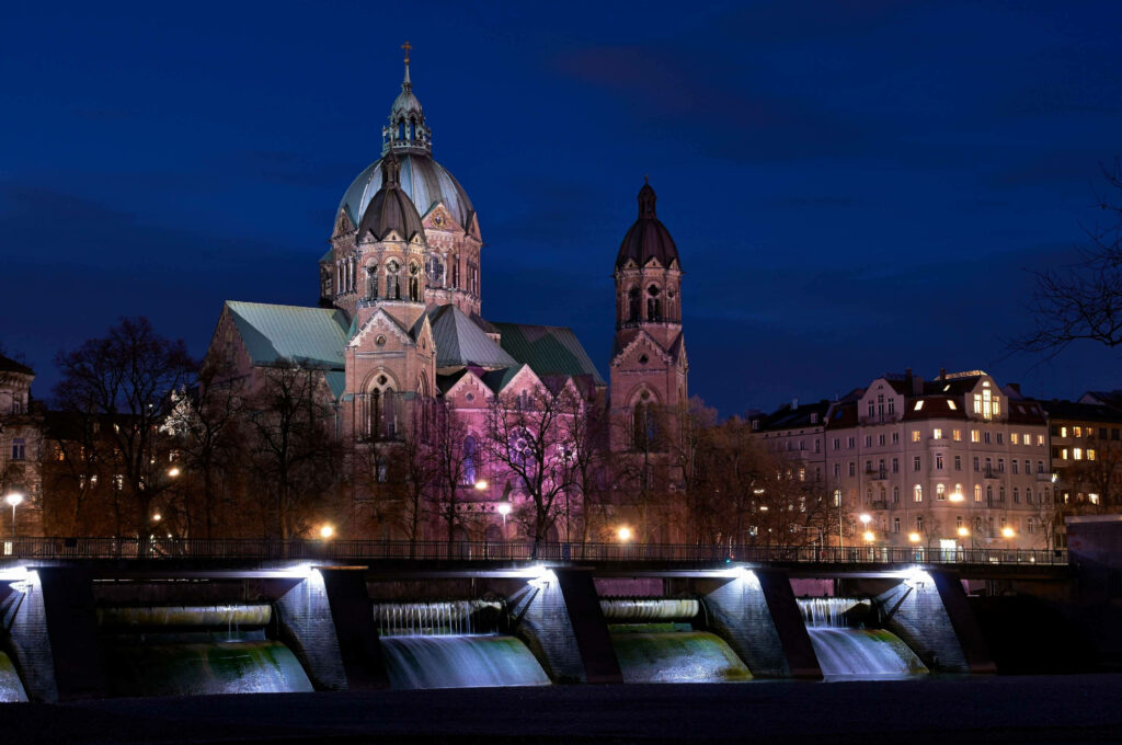 St Lukes Church Munich illuminated at night riverside cityscape with stunning architecture background Wallpaper