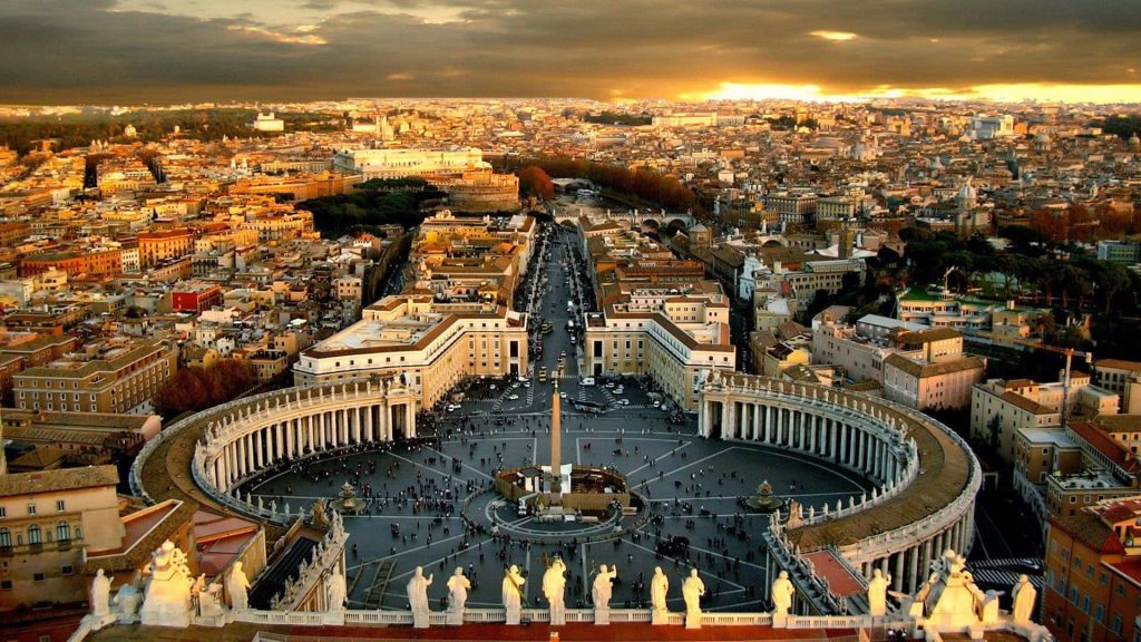 Aerial view of St Peters Square at sunset with colonnade and obelisk in Vatican City Rome Wallpaper