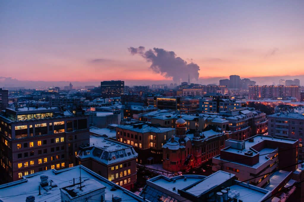 Stunning Rooftop Cityscape: Colorful Sunset Wallpaper Background
