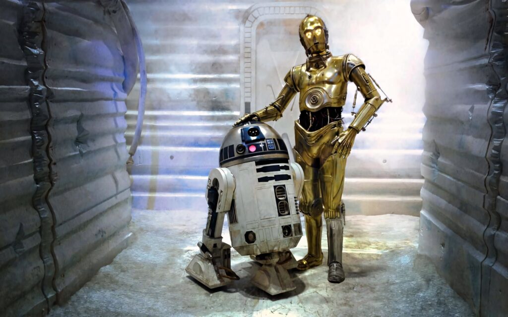 Star Wars wallpaper with C-3PO and R2-D2 in a detailed metallic sci-fi corridor background