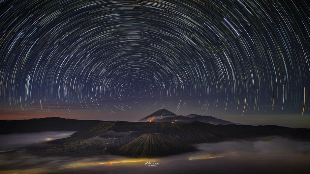 Nighttime Journey Through the Celestial Tapestry: Captivating HD Wallpaper featuring Star Trail Phenomenon