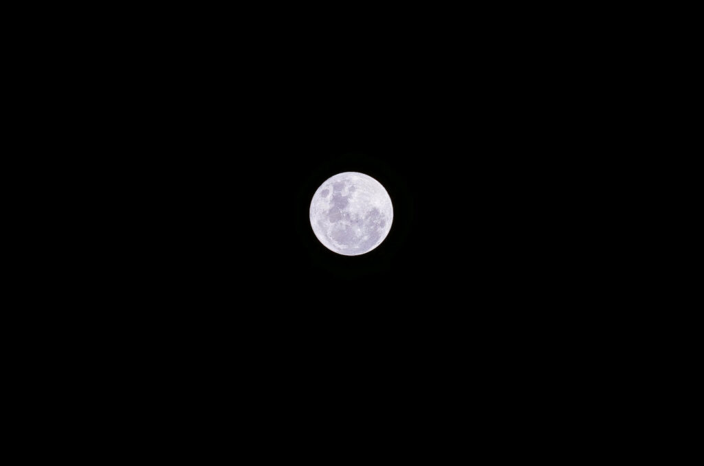 High contrast detailed full moon against black background minimalist lunar surface wallpaper