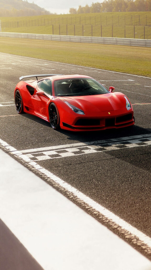 Racing Excitement: Stunning Snapshot of a Ferrari 488 Red Car Ready to Rocket off the Starting Line Wallpaper