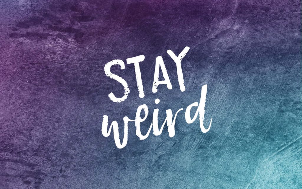 Stay Weird quote wallpaper with bold script typography on purple to cyan textured gradient background