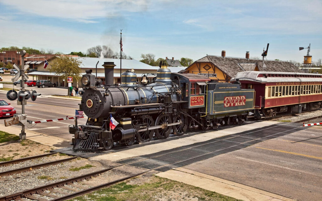 Journey through Time: Exploring Magnificent Landscapes on a Vintage Steam Locomotive Train Wallpaper