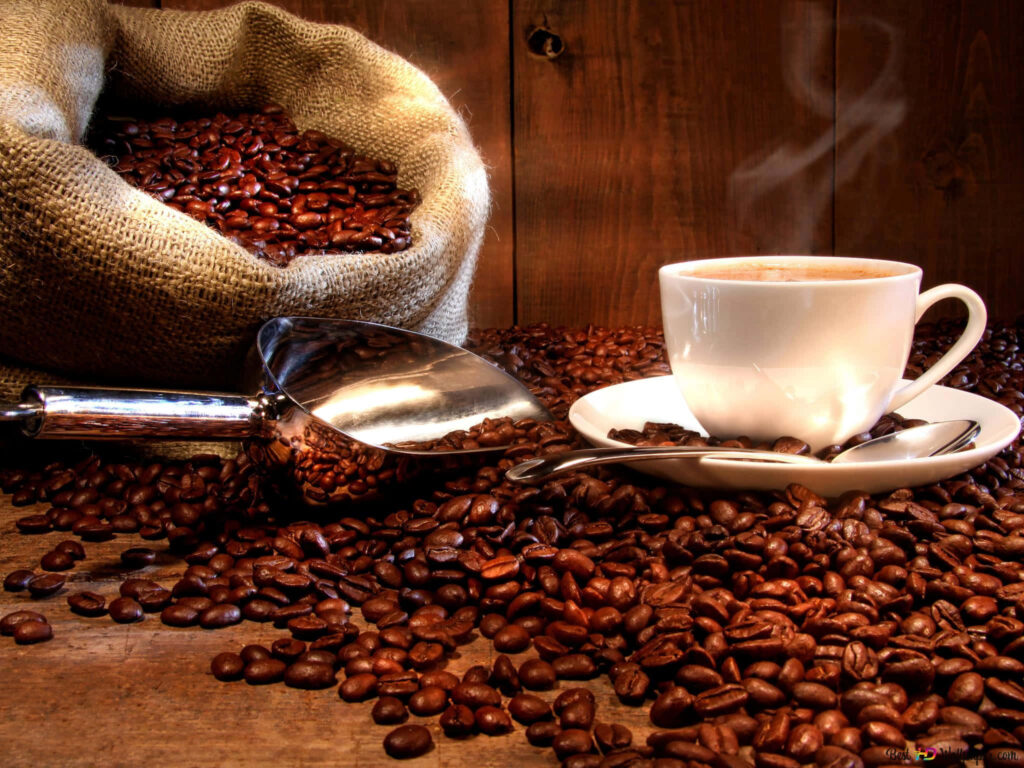 Steaming coffee cup on rustic table with red beans scoop burlap sack warm cozy scene Wallpaper