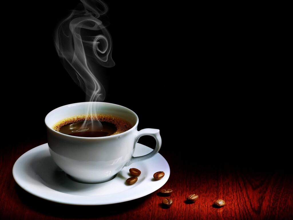 Steaming White Coffee Cup on Wooden Table - Dark Background Wallpaper