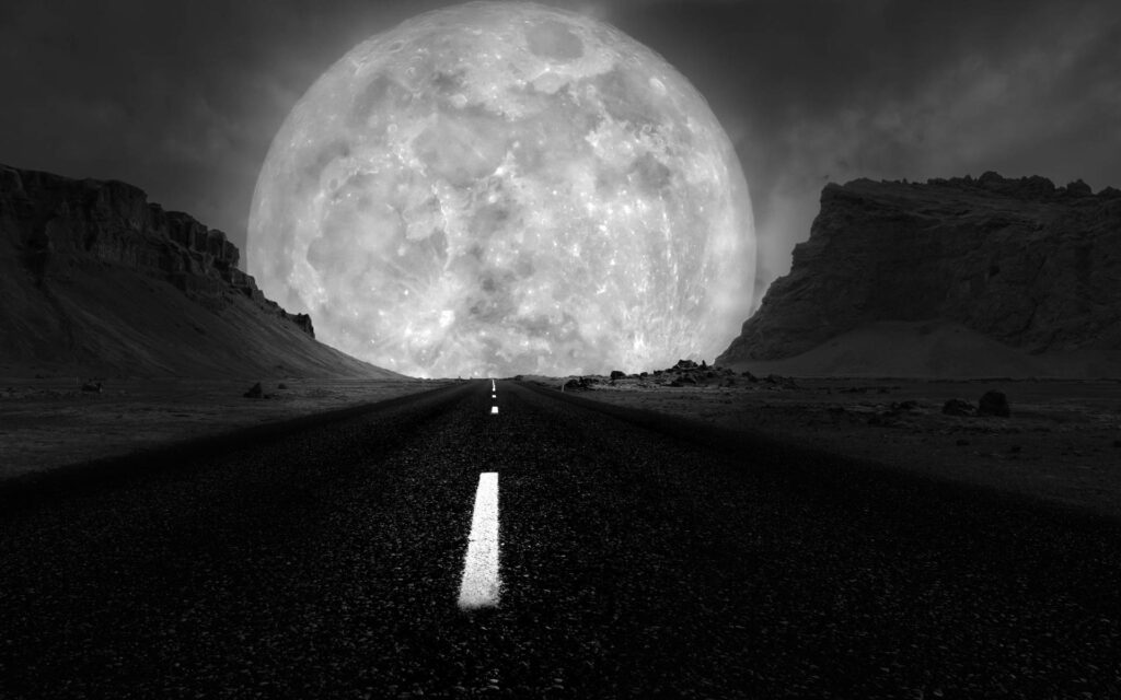 Mystical Night Drive: Mesmerizing Monochrome Road Encased Between Majestic Mountains, Under the Majestic Galaxy Moon Wallpaper