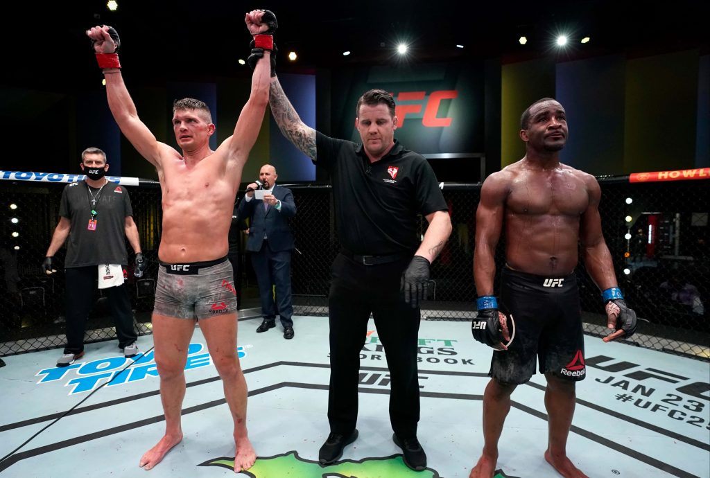 Stephen Wonderboy Thompson celebrating UFC victory over Geoff Neal in bright arena lights Wallpaper
