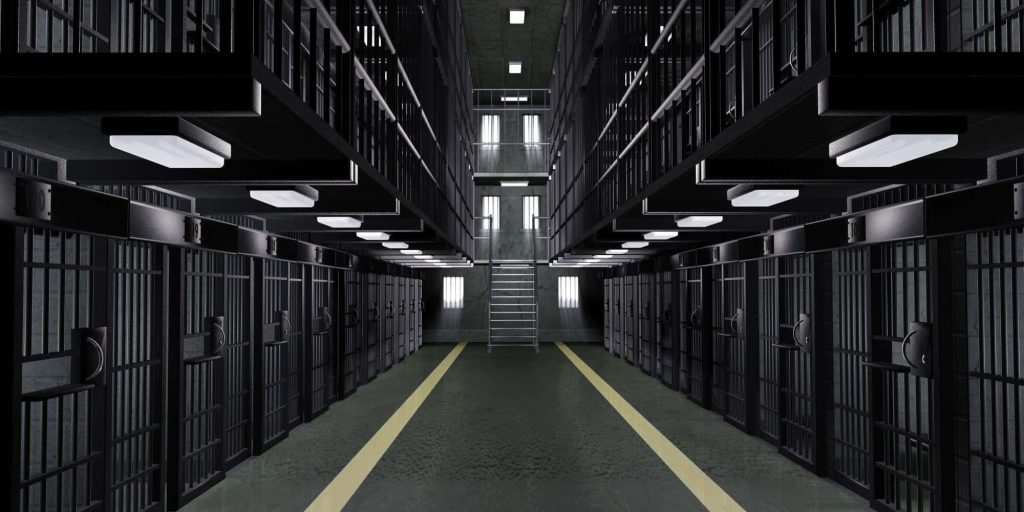 Sterile 3D prison interior with symmetric cell block corridor bright lights and dark metal bars Wallpaper