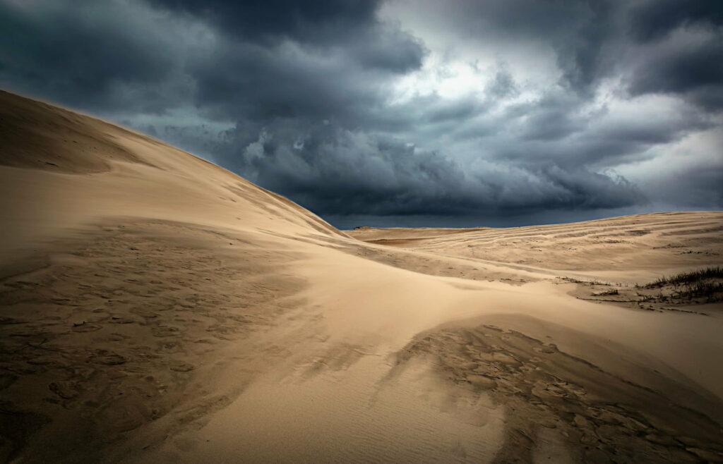 Stormy Clouds Over Sand Dunes: Dramatic HD Wallpaper Background