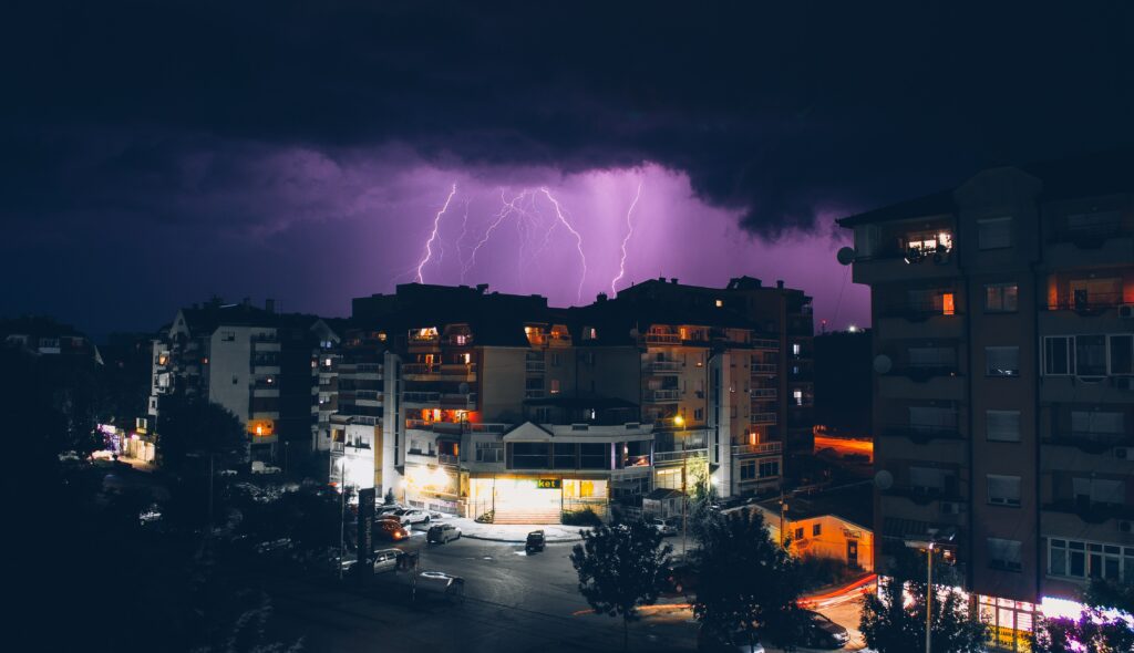 Dramatic Thunderstorm Wallpaper: Nighttime Buildings & Lightning Sky