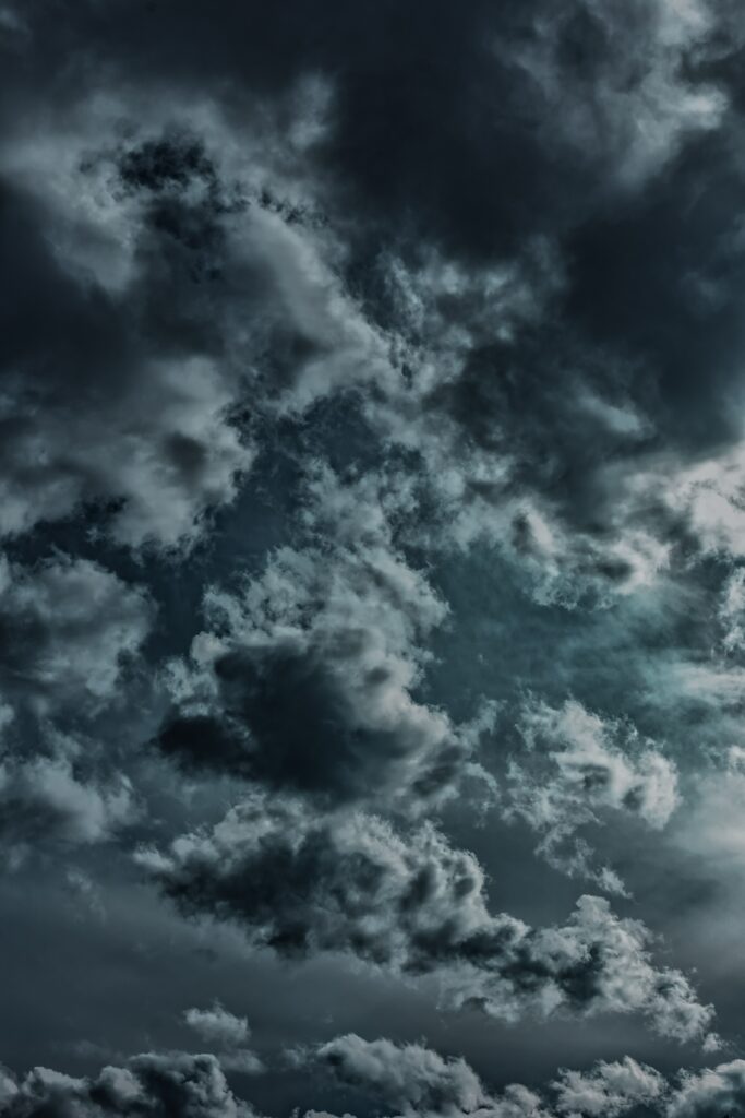 Stormy sky wallpaper with dense dark clouds and deep gray blue tones capturing intense mood