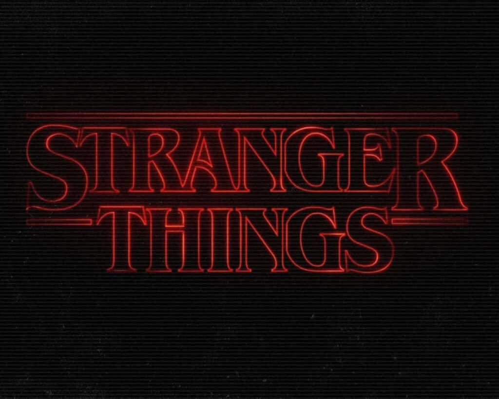 Stranger Things 2016 Movie Poster Unveiling a Stylishly Glowing Red Font Against an Enigmatic Black Backdrop Wallpaper
