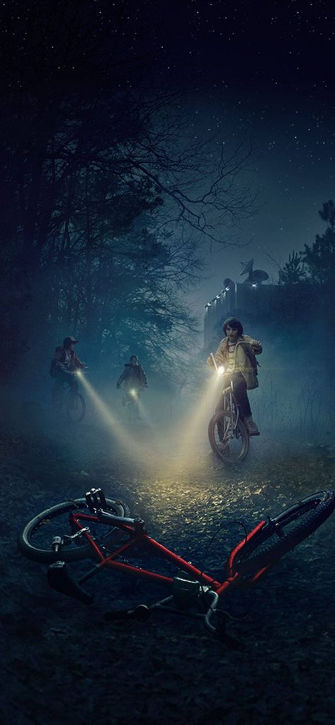 Stranger Things wallpaper with Mike and friends cycling through foggy forest to Hawkins Lab at night