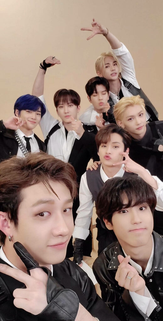 Stray Kids energetic members striking dynamic stage poses vibrant Kpop wallpaper background