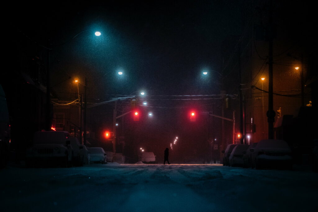 Enchanting Snowy Streets: Captivating Silhouettes Amidst the Night - HD Wallpaper Background