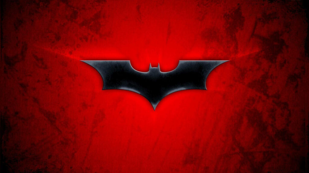 Striking Batman logo wallpaper with sleek black bat symbol on textured bold red background
