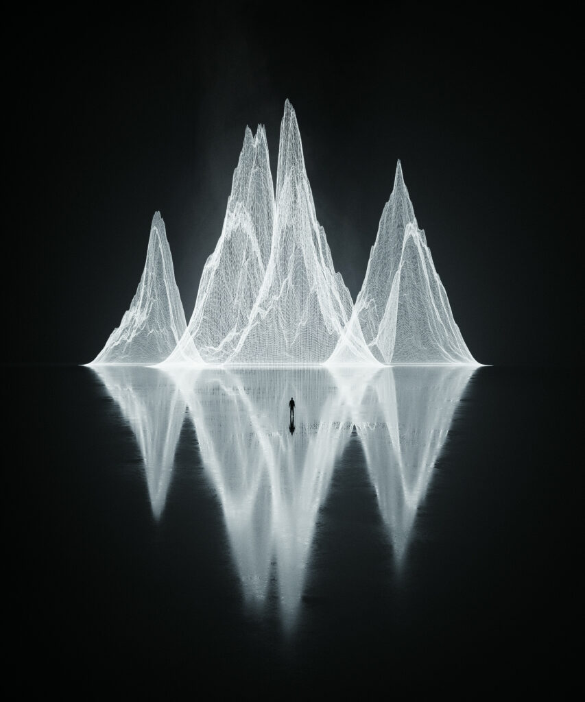 Striking Black and White Wallpaper: Man & Jagged Rocks Reflection
