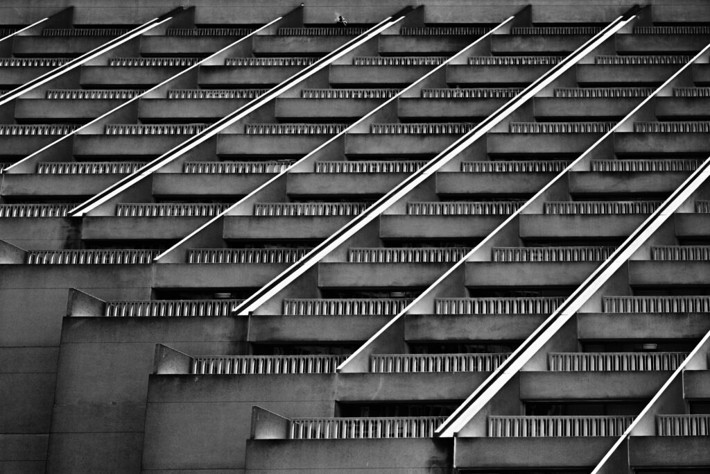 Striking Black and White Striped Building Facade Wallpaper Background