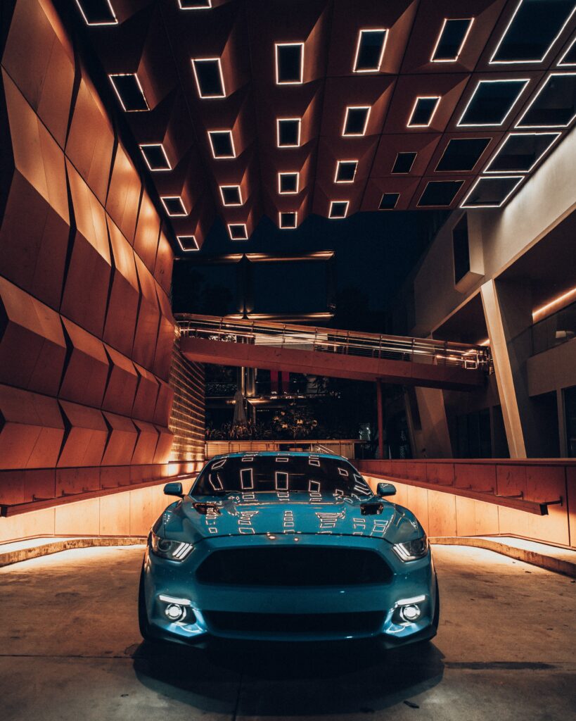 Sleek Blue Sports Car Wallpaper in Unique Architectural Setting