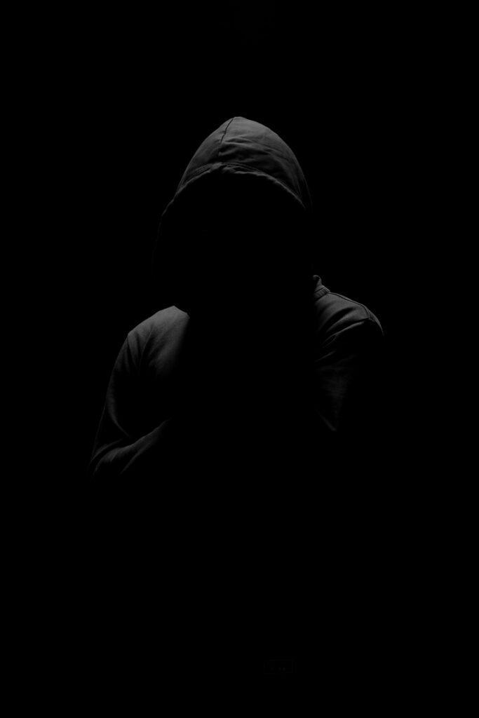 Mysterious Hooded Figure Wallpaper: Dark & Intriguing Background