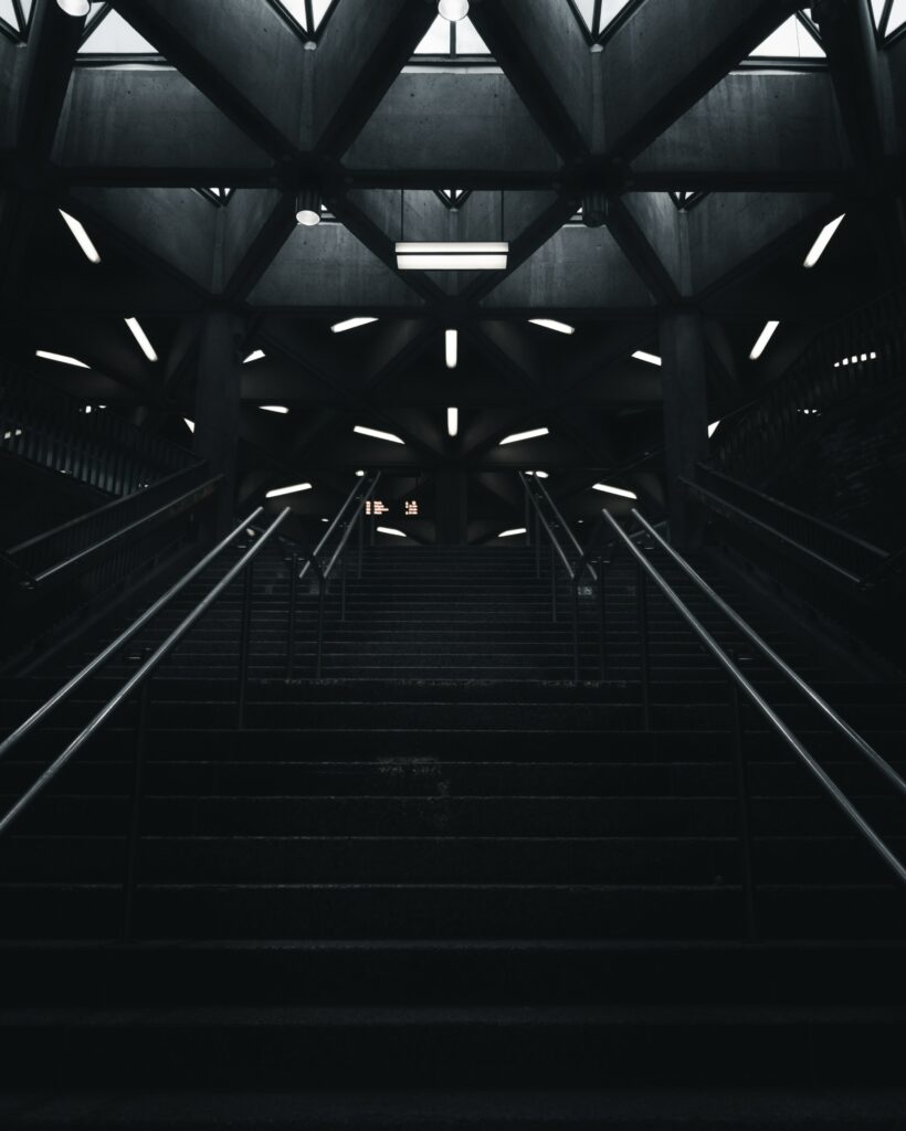 Striking Dimly Lit Staircase Wallpaper in Modern Architecture