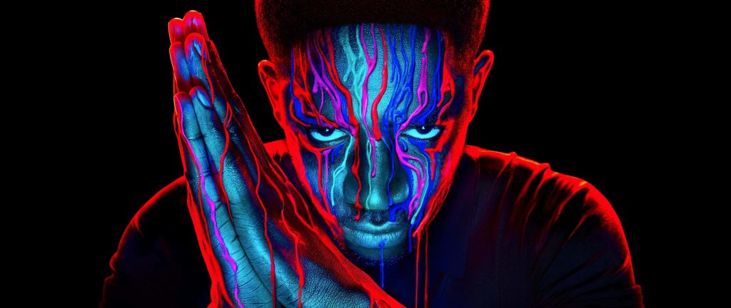 Franklin Saint from Snowfall digital art with neon paint dripping on face and praying hands black background Wallpaper