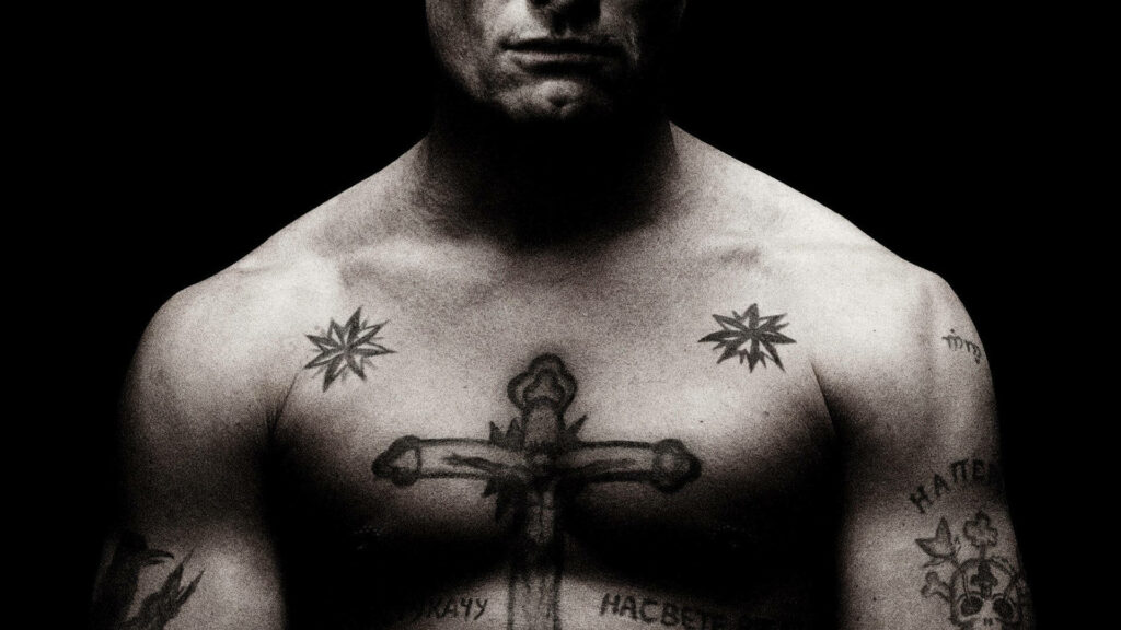 Greyed-out Glory: Striking Cross Chest Tattoo Wallpaper
