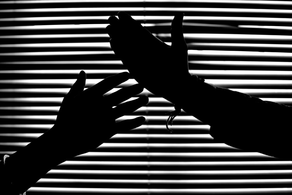 Striking Hands Silhouette Against Window Blinds - Dramatic Background Wallpaper