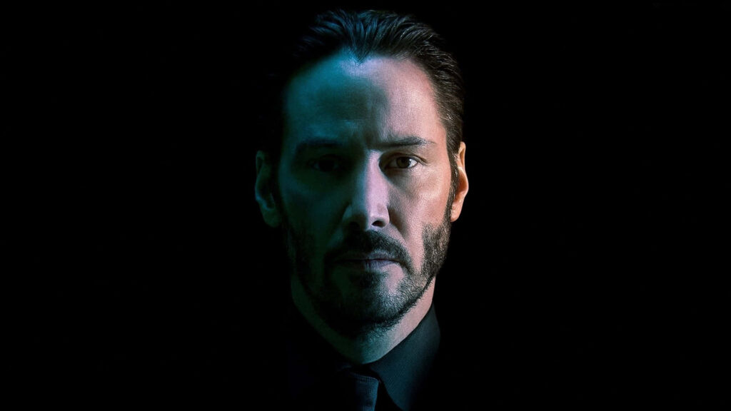 Intense Keanu Reeves Wallpaper: Iconic Presence on Dark Background