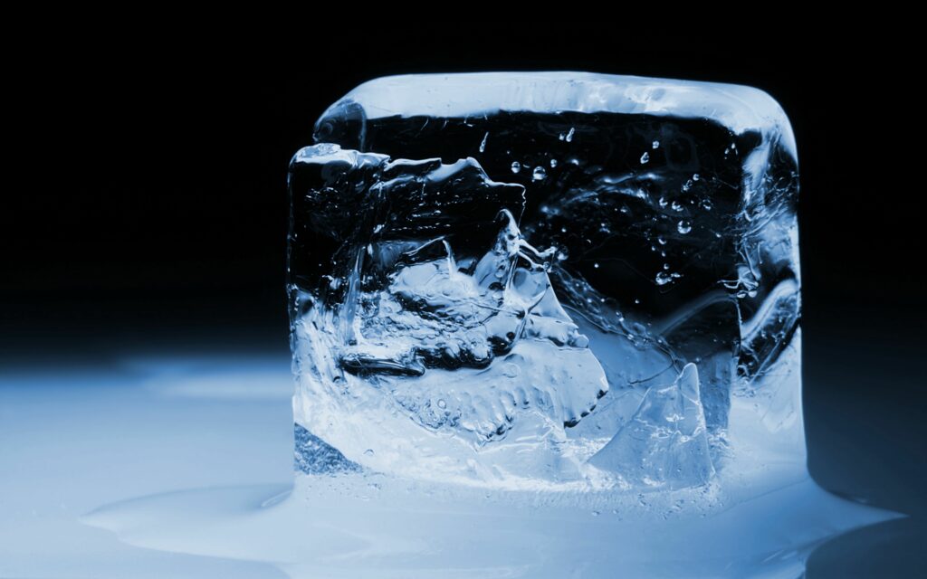 Stunning Ice Cube Macro Wallpaper: Textured Blue Design on Dark Background