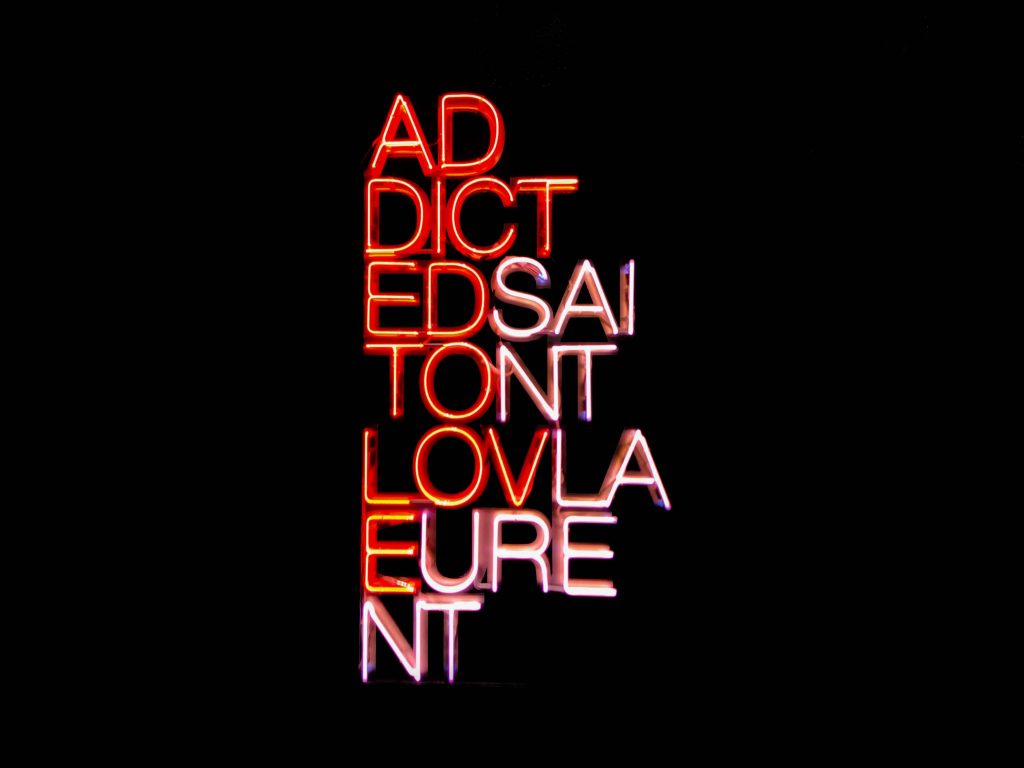 Neon sign wallpaper with layered red white typography on black background urban edgy design