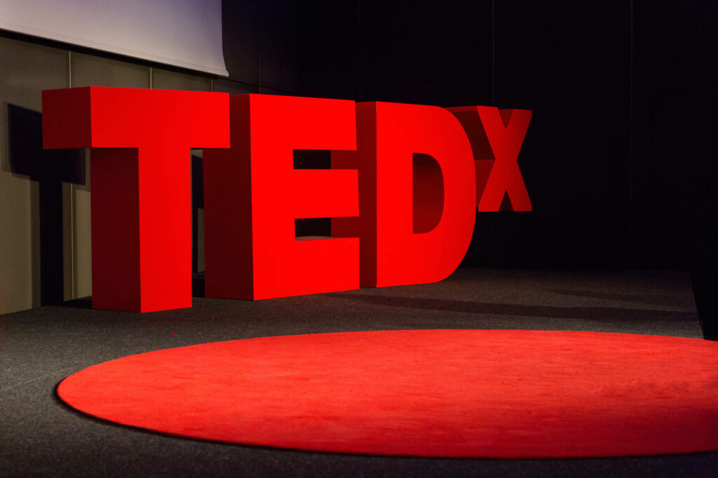 Bold 3D TEDx Logo Wallpaper on Red Carpet Stage Background