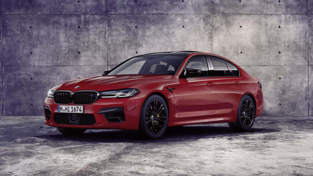 Striking red BMW parked by textured gray concrete wall bold contrast modern automotive background Wallpaper