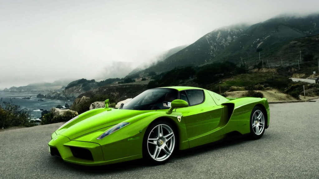 Roaring Elegance: Capturing the Majestic Ferrari Enzo as it Embodies Power and Luxury on the Open Road Wallpaper