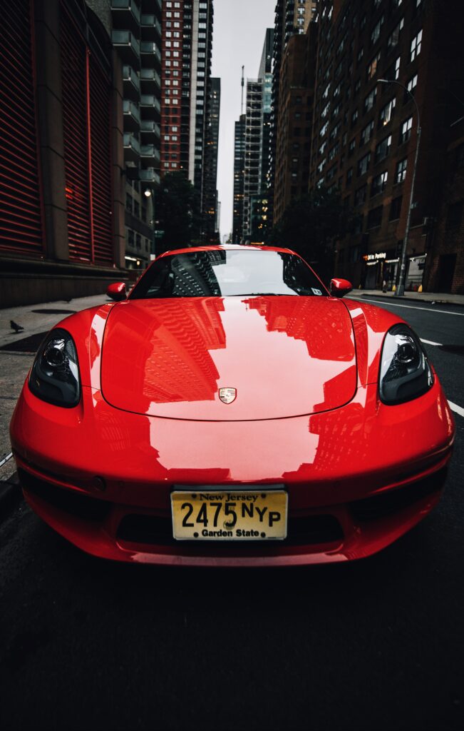 Vibrant Red Ferrari Wallpaper: Elegance and Speed in Urban Setting