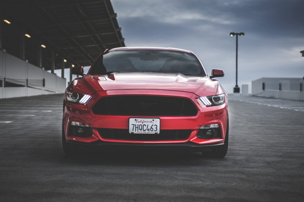 Red Ford Mustang Front View on Racetrack - Stunning Wallpaper