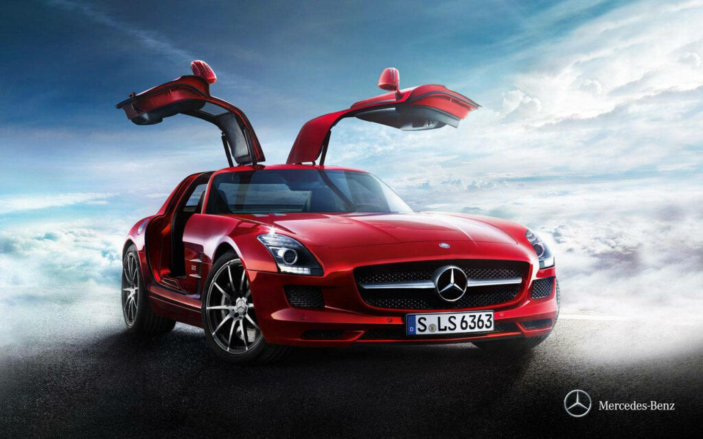 Red Mercedes-Benz SLS AMG with gullwing doors open against dramatic sky sports car wallpaper