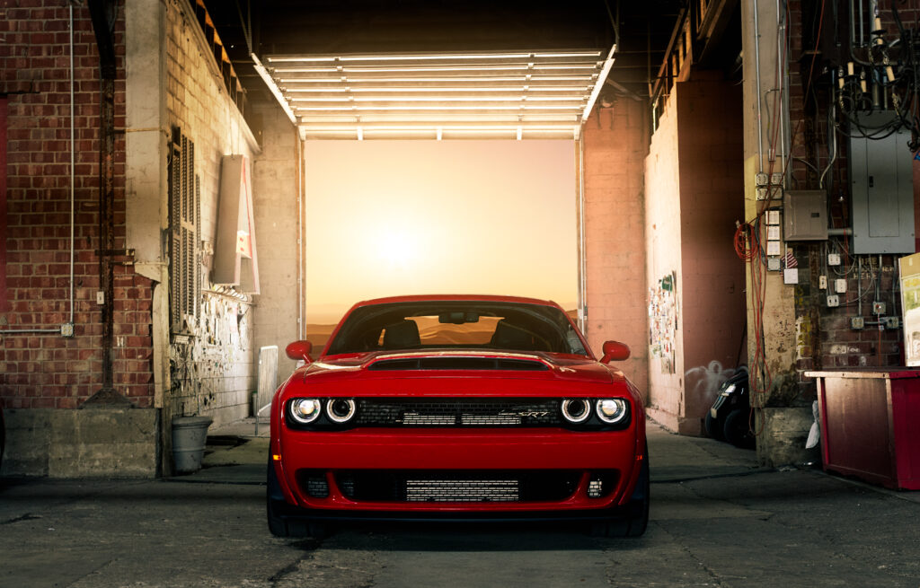 Striking Red Muscle Car in Urban Sunset - Bold Design & Gritty Backdrop Wallpaper