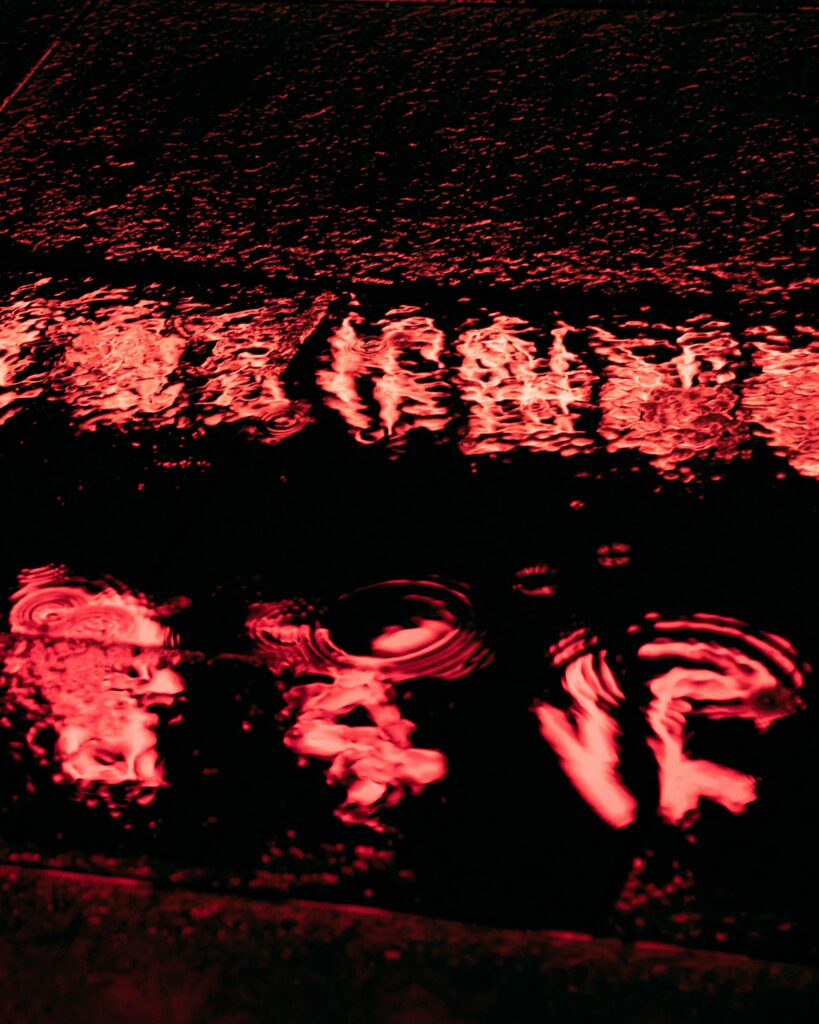 Vibrant Wallpaper: Dark Puddle with Striking Red Reflection