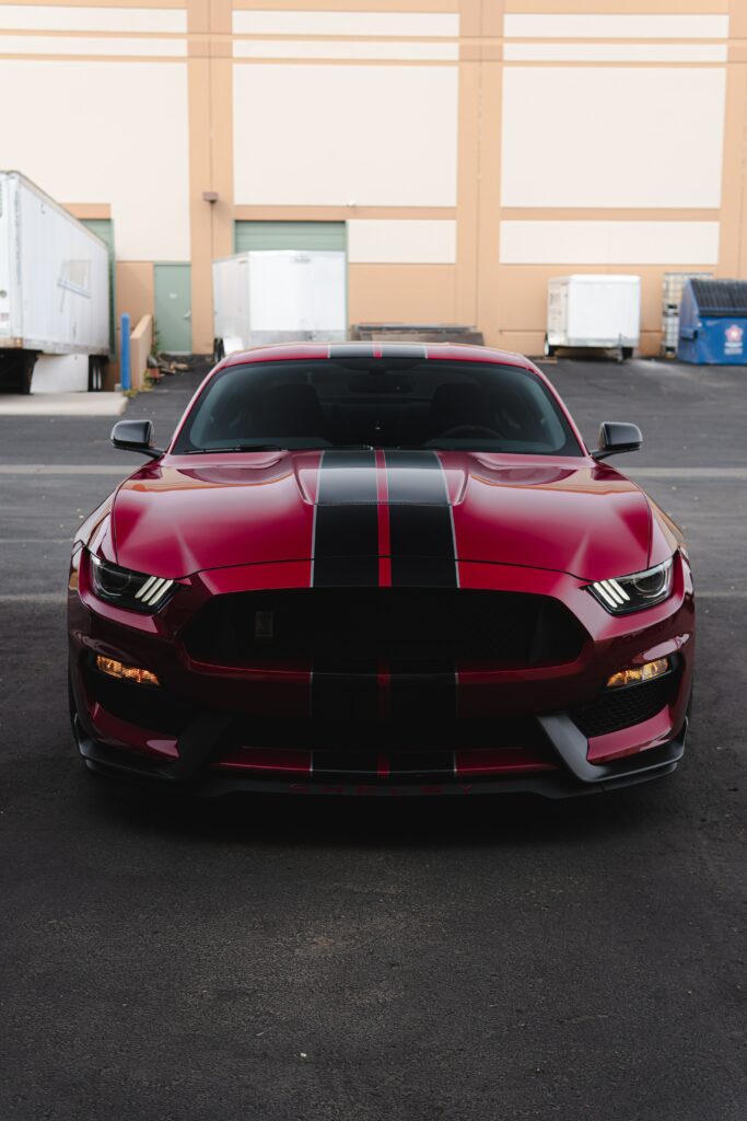 Dynamic Red Sports Car Wallpaper with Bold Racing Stripes