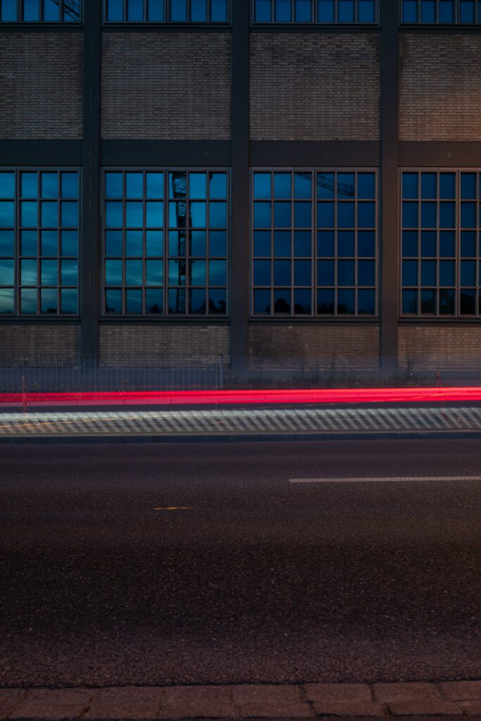 Dynamic Wallpaper: Building with Grid Windows & Red Light Long Exposure