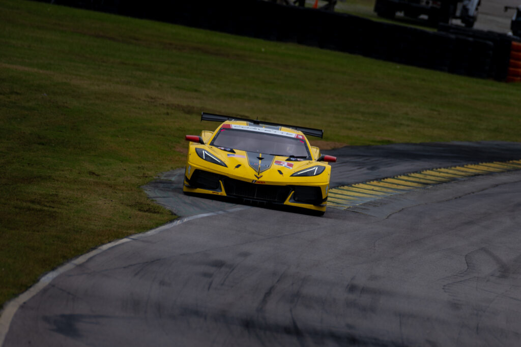 Dynamic Yellow Chevrolet Corvette Race Car on Track Wallpaper